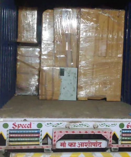 Experienced packers and movers in Kanpur navigating a delivery van through a local Kanpur neighborhood.